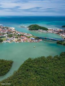an island with a bridge in the middle of the water at Pousada Encanto De Itanhaém in Itanhaém