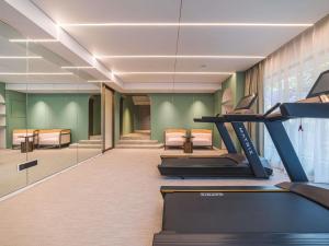 a room with a gym with a treadmill at Mercure Xishuangbanna in Jinghong