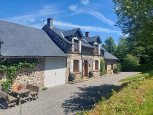 a stone house with a picnic table in front of it at Holiday Home in Limoges with Saltwater Pool in Châteauneuf-la-Forêt