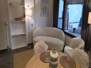 a living room with a table and two chairs and a table and a table at Sunny Cottage with Pool in Purnode
