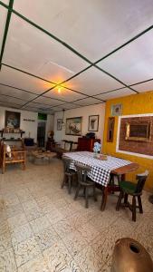 a living room with a table and chairs and a couch at Eco Finca El Regalo in Salento