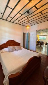 a bedroom with a large bed and a dining room at Eco Finca El Regalo in Salento