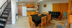 a kitchen and dining room with a table and chairs at Balcón a las sierras - Cervantes 273 - La Falda in La Falda