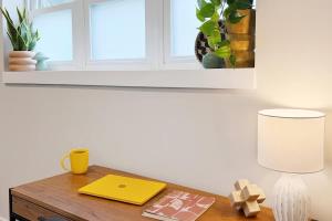 a desk with a lamp and a book on it at 1500 Sq ft Space 2 Bed 2 Bath Large Kitchen in Conshohocken