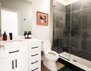 a bathroom with a toilet and a glass shower at 1500 Sq ft Space 2 Bed 2 Bath Large Kitchen in Conshohocken