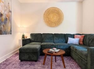 a living room with a blue couch and a table at 1500 Sq ft Space 2 Bed 2 Bath Large Kitchen in Conshohocken