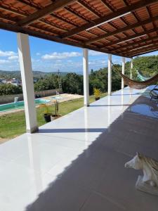 a patio with a hammock and a view of a pool at Pousada Recanto do Oásis in Triunfo