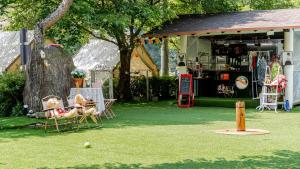 a garden with a table and chairs on the grass at Gapyeong Jmong Choncance&Camping Pension in Gapyeong +4 photos