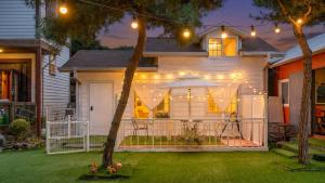 a house with a patio with a table and chairs at Gapyeong Jmong Choncance&Camping Pension in Gapyeong