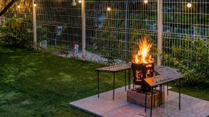 a fire pit in a yard with flames in it at Gapyeong Jmong Choncance&Camping Pension in Gapyeong