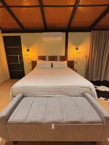 a bedroom with a large white bed in a room at Villa Iñaru hospedaria in Aquidauana +32 photos