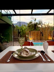 a plate on a table with a napkin on it at Villa Iñaru hospedaria in Aquidauana