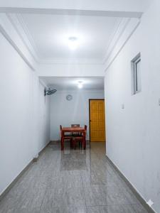 a room with a table and a yellow door at D'Rembulan Homestay in Ranau