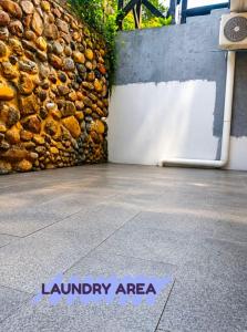 a sign that says laundry are a on a sidewalk at D'Rembulan Homestay in Ranau
