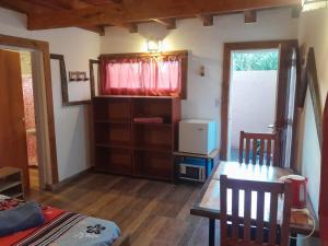 a room with a table and a dining room at Mi Refugio APART in El Chalten