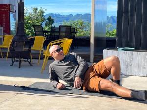 a man laying on the ground on the sidewalk at Black Stone Hilltop Great Wall Lodge & Whisky Lounge in Simataicun