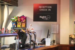 a reception check in counter with a sign on the wall at Nightcap at Wanneroo Tavern in Wanneru