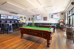 a billiard room with two pool tables and a bar at Nightcap at Wanneroo Tavern in Wanneru