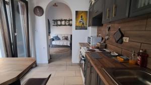 a kitchen with a sink and a counter top at The Village Retreat in Malona Village