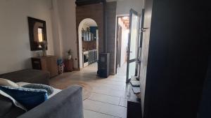 a living room with a couch and a kitchen at The Village Retreat in Malona Village
