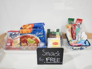 a table with some food and a sign that reads snack for free at Impact MT House in Ban Bang Phang +10 photos