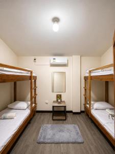 a room with two bunk beds and a table at Bayay Isla Inn in General Luna