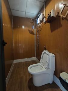 a bathroom with a toilet with the lid up at La An Homestay in Vĩnh Hy