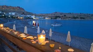 a long table with lights on it next to a body of water at The Village Retreat in Malona Village