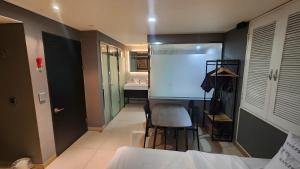a bedroom with a large screen in the middle of a room at Sixty Hotel in Seoul