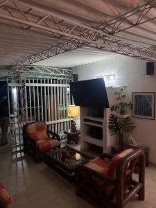 a living room with a couch and a chair at Villa Nacha in Villeta