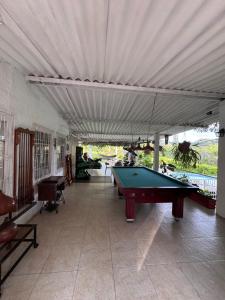 a pool table in a living room with a canopy at Villa Nacha in Villeta +6 photos