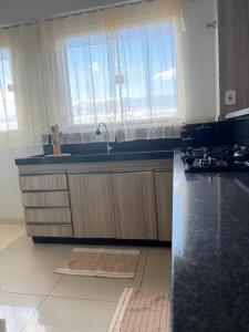 a kitchen with a sink and a counter top at Apartamento completo in Nova Mutum