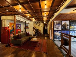 a living room with a couch and a table at Snow Monkey Lodge in Yamanouchi