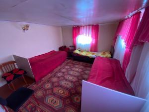 a small room with a bed and a laptop in it at ILGIZ HOUSE Barskoon in Barskoon