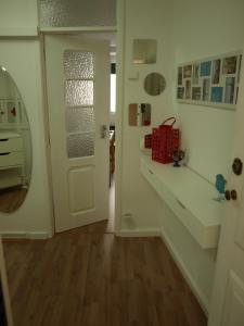 a hallway with a white door and a stair case at Casa Beco Do Castelo in Lisbon