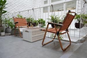 two chairs sitting on a porch with a washing machine at 389 Hz Homestay in Danang