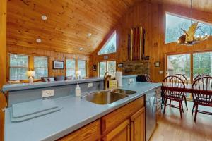a kitchen with a sink and a dining room at Beaver Glen in Vermont Ventures +43 photos