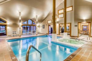 a large pool with a hot tub in a building at Trail Creek 75 in Killington