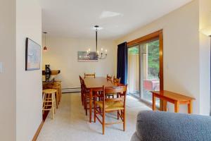 a kitchen and dining room with a table and chairs at Trail Creek 75 in Killington