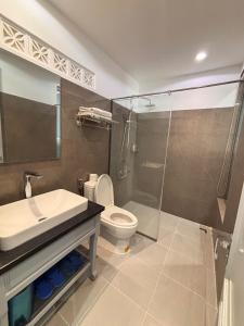 a bathroom with a sink and a toilet and a shower at Khách Sạn PG Boutique in Vung Tau +13 photos