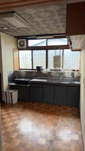 a kitchen with a sink and a counter top at Tomaru細野 in Nobezawa +14 photos
