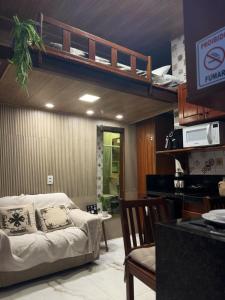 a bedroom with a bunk bed and a couch at Condomínio Feitosa Barros I in Maceió