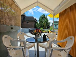 a table and chairs on a patio with an umbrella at 행궁동-House1 in Suwon