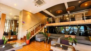 a lobby with a staircase in a building at Vio Hotel Pasteur in Bandung