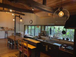 a kitchen with a table and a dining room at Homestay HANIHOHETO in Ena