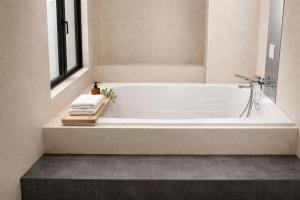 a white bath tub in a bathroom with a window at Hotel Piatt Nagoya in Nagoya +18 photos