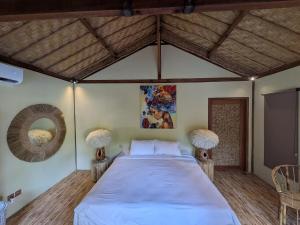 a bedroom with a large bed in a room at Meno Lagoon Bungalows in Gili Meno +23 photos