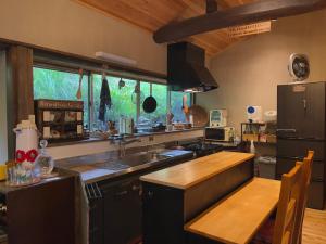 a kitchen with a sink and a wooden table at Homestay HANIHOHETO in Ena +31 photos