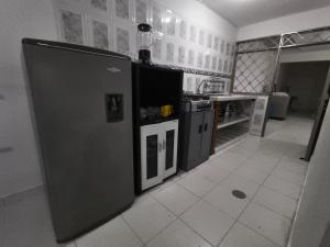 a kitchen with a black refrigerator in a room at Felipe's House in Ibagué