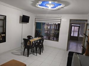 a dining room with a table and chairs and a chandelier at Felipe's House in Ibagué